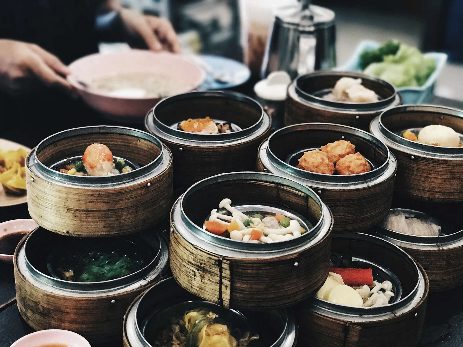 A table of Cantonese dim sum in stacked bamboo baskets